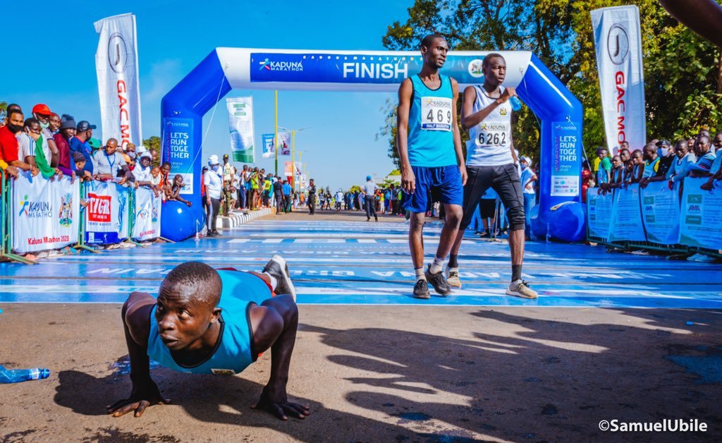 A runner celebrating at the Kaduna Half Marathon finish line